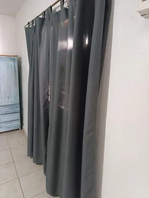 a row of black curtains hanging on a wall at Departamento tolosa in Cordoba