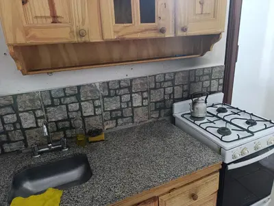 a kitchen with a stove and a counter top at Departamento tolosa in Cordoba