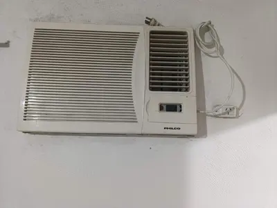 a white air conditioner hanging on a wall at Departamento tolosa in Cordoba
