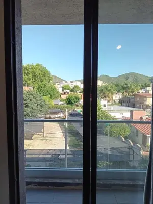 a window with a view of a city at Sam Lake 3 in Villa Carlos Paz