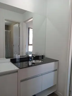 a white bathroom with a sink and a mirror at Sam Lake 3 in Villa Carlos Paz