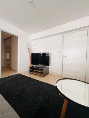 a living room with a glass table and a tv at Cardinales in Cordoba