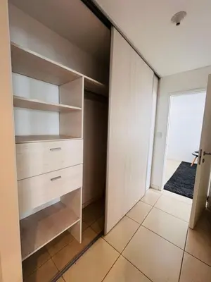a walk in closet with wooden cabinets and a window at Cardinales in Cordoba