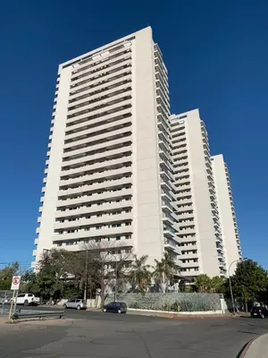 a large white building with cars parked in front of it at Cardinales in Cordoba