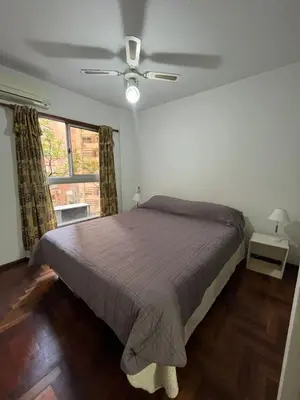 a bedroom with a bed and a ceiling fan at poeta lugones - nva cba in Cordoba
