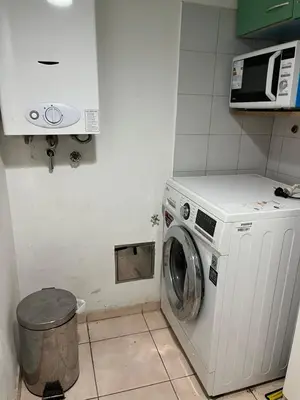 a washing machine in a kitchen with a microwave at poeta lugones - nva cba in Cordoba