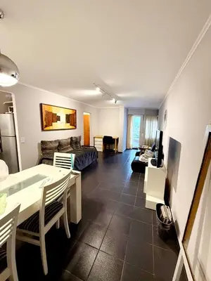 a living room with a table and a couch at Amplio, luminoso y cerca de todo! in Cordoba