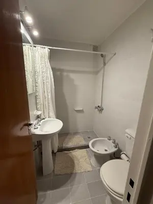 a small bathroom with a toilet and a sink at Amplio, luminoso y cerca de todo! in Cordoba