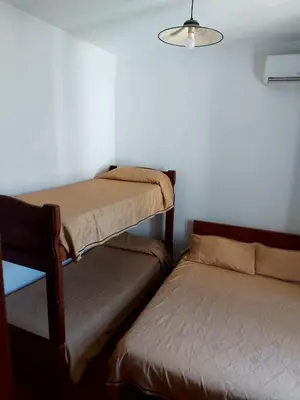 a room with two bunk beds and a lamp at Castillo Del Lago - Carlos Paz - D18 in Villa Carlos Paz