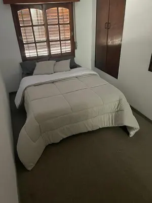 a large bed in a bedroom with a window at Casa de Gregorio Hostel in Cordoba