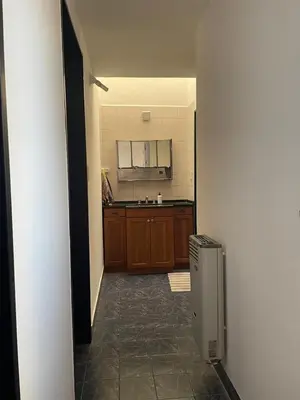 a room with a kitchen with a refrigerator at Casa de Gregorio Hostel in Cordoba