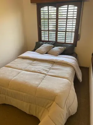 a large bed in a room with a window at Casa de Gregorio Hostel in Cordoba
