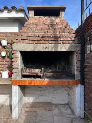 a brick oven with a pizza inside of it at Casa completa con pileta y asador, a metros del lago in Villa Carlos Paz