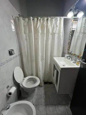 a bathroom with a toilet and a sink at Casa completa con pileta y asador, a metros del lago in Villa Carlos Paz