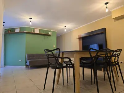 a dining room with a table and chairs and a couch at ByB ALQUILERES 3 in Cordoba