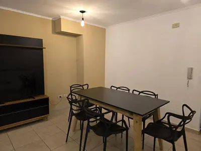 a dining room with a table and chairs and a television at ByB ALQUILERES 3 in Cordoba