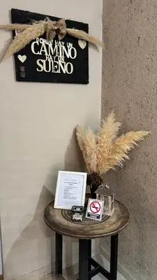 a table in a room with a sign on a wall at Apart Suipacha in Río Cuarto