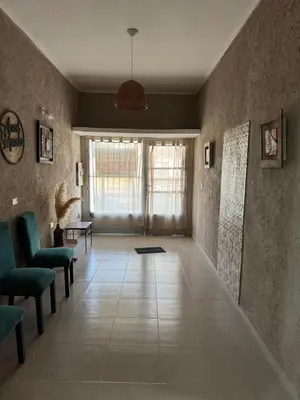 a living room with chairs and a large window at Apart Suipacha in Río Cuarto