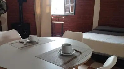 a room with a table and chairs and a bed at Departamento en Nono Descanso y aventura in Nono