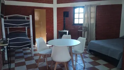 a room with a bed and a table and chairs at Departamento en Nono Descanso y aventura in Nono