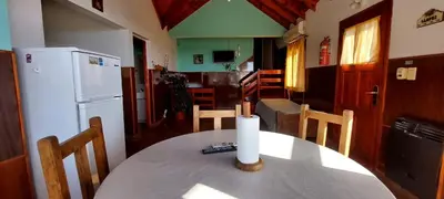 a kitchen and dining room with a table and a refrigerator at Sierra madre 2 in El Rincón