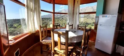 a kitchen with a table and chairs in front of a window at Sierra madre 2 in El Rincón
