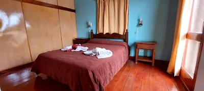 a bedroom with a bed with two stuffed animals on it at Sierra madre 2 in El Rincón