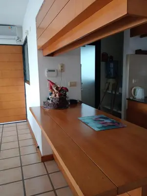 a kitchen with a wooden counter top in a room at Casa Carlos Paz Terrazas del Lago in Villa Carlos Paz