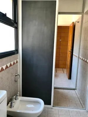 a bathroom with a shower and a toilet and a sink at Casa Carlos Paz Terrazas del Lago in Villa Carlos Paz