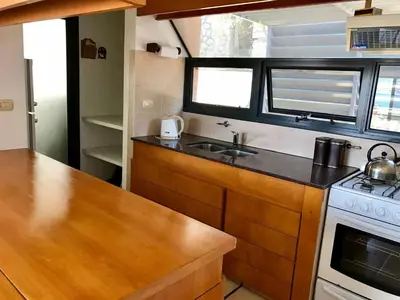 a small kitchen with a sink and a stove at Casa Carlos Paz Terrazas del Lago in Villa Carlos Paz