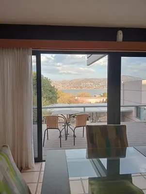 a view of a balcony with a table and chairs at Casa Carlos Paz Terrazas del Lago in Villa Carlos Paz
