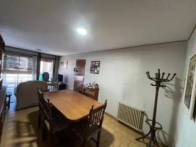 a dining room with a wooden table and chairs at Amplio departamento en Cofico in Cordoba