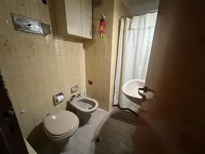 a bathroom with a toilet and a sink at Amplio departamento en Cofico in Cordoba