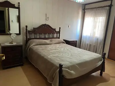 a bedroom with a bed and a dresser and a mirror at Amplio departamento en Cofico in Cordoba