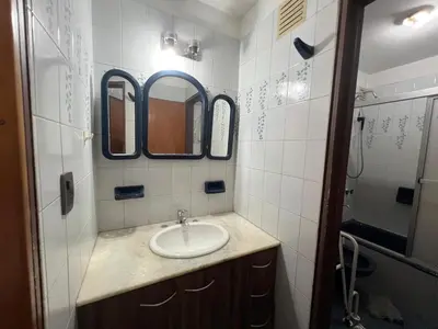 a bathroom with a sink and two mirrors at Amplio departamento en Cofico in Cordoba