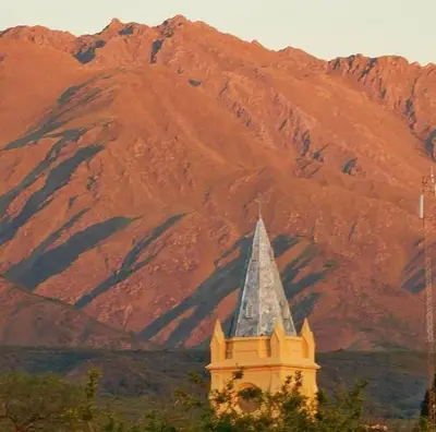 a clock tower with a mountain in the background at Rancho Eco Loft in San Javier