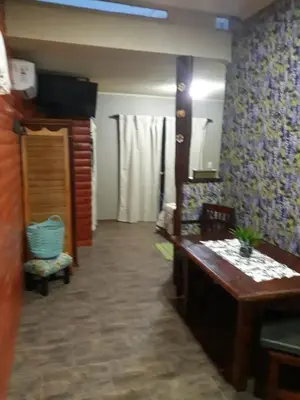 a living room with a desk and a room with a unintention at Fragancias Serranas in Cortaderas