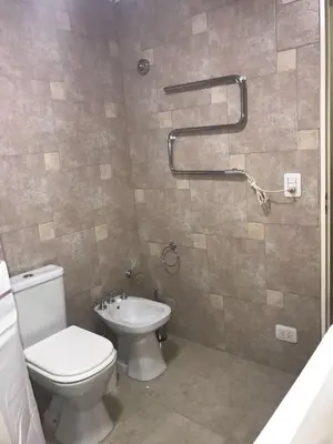 a bathroom with a toilet and a sink at Fragancias Serranas in Cortaderas