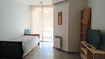 a bedroom with a bed and a flat screen tv at Exelente departamento en Carlos Paz in Villa Carlos Paz