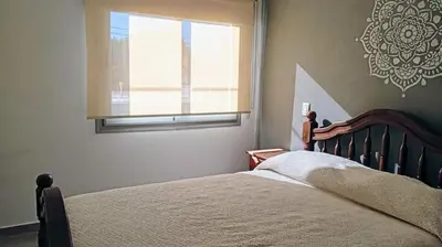 a bedroom with a bed and a window at Exelente departamento en Carlos Paz in Villa Carlos Paz