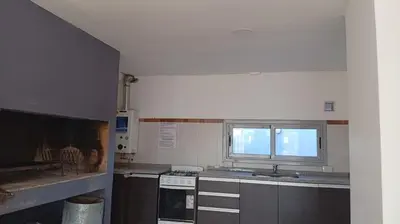 a kitchen with a sink and a stove and a window at Exelente departamento en Carlos Paz in Villa Carlos Paz
