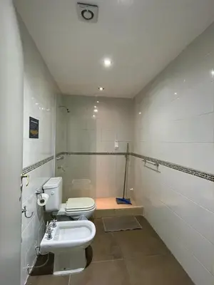 a bathroom with a toilet and a sink at Central Suites Hotel in Villa Carlos Paz