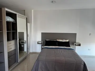 a bedroom with a bed and a large mirror at LOFT Santa Rita in Villa Carlos Paz
