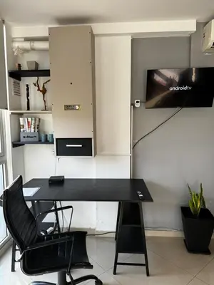 a black desk with a chair in a room at LOFT Santa Rita in Villa Carlos Paz