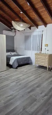 a bedroom with a bed and a wooden floor at monoamb moderno in Cordoba
