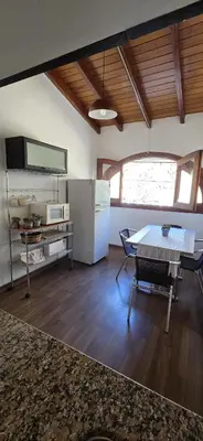 a living room with a table and a refrigerator at monoamb moderno in Cordoba