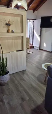 a living room with wood floors and a couch and a table at monoamb moderno in Cordoba