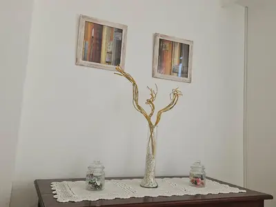 a table with a vase with a tree in it at Urban 360 in Río Cuarto