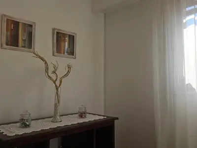 a room with a table with a vase with a tree at Urban 360 in Río Cuarto
