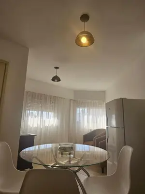 a living room with a glass table and a refrigerator at Urban 360 in Río Cuarto